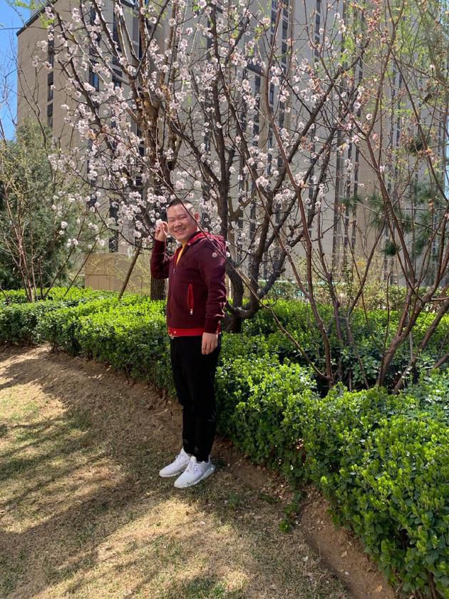 岳云鹏打扮休闲与花树合影笑容灿烂被赞很可爱