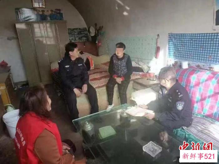 资料图：李刚(右一)到居民家中走访。　长治警方供图