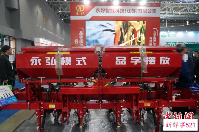 图为观众围观免耕播种机。　韩章云 摄